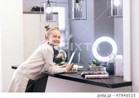 Cute blue-eyed long-haired girl with a nice hairstyle feeling positive 47940523