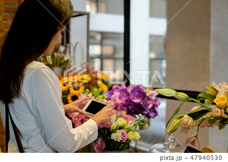 Cheerful charming young business owner flower shop Cheerful charming young business owner flower shop 47940530