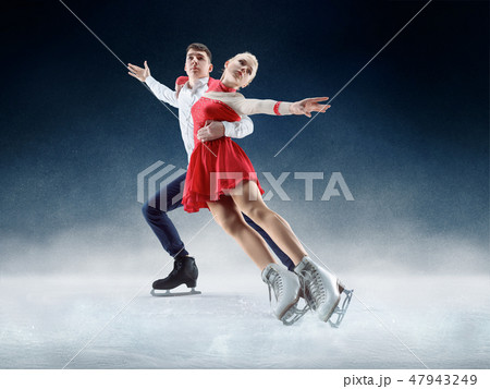 Professional man and woman figure skaters performing on ice show 47943249