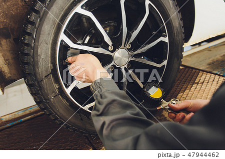 Car Tire Pressure Check in the Auto Service Garage. 47944462
