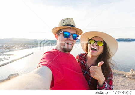 Travel, vacation and holiday concept - Happy couple taking selfie over beautiful landscape Travel, vacation and holiday concept - Happy couple taking selfie over beautiful landscape 47944910