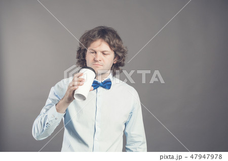 Close up portrait of happy handsome man in blue shirt with paper cup of morning coffee. Good morning 47947978