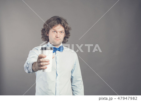 Close up portrait of happy handsome man in blue shirt with paper cup of morning coffee. Good morning 47947982