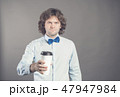 Close up portrait of happy handsome man in blue shirt with paper cup of morning coffee. Good morning 47947984