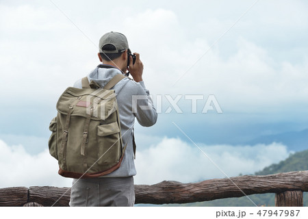 Young man travel photographer taking nature photo 47947987