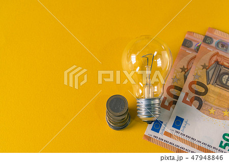 Light Bulb and european banknotes and coins 47948846