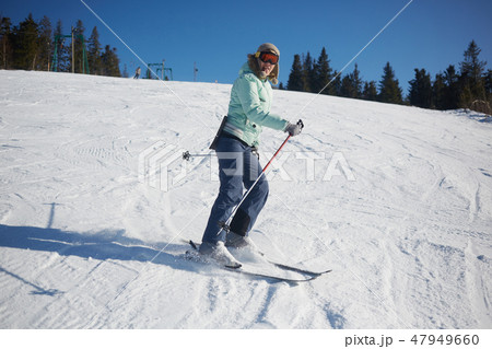 The young female skier in downhill slope. 47949660
