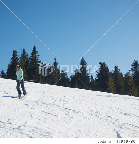 The young female skier in downhill slope. The young female skier in downhill slope. 47949730