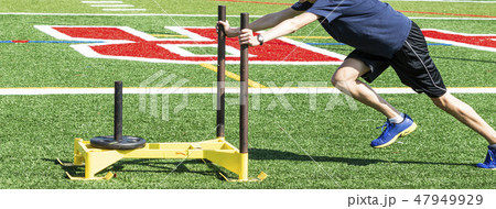 Pushing yellow sled with weight Pushing yellow sled with weight 47949929