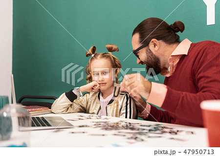 Pretty fair-haired girl with bracelets on her hand looking distressed Pretty fair-haired girl with bracelets on her hand looking distressed 47950713