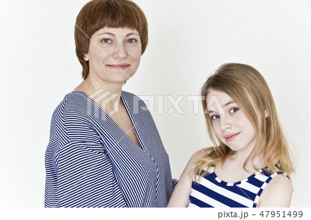 Beautiful mother and daughter on white 47951499