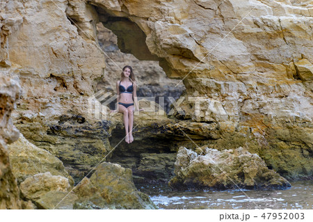 Young girl in black bikini 47952003