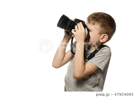Boy takes pictures on camera. Portrait. Isolate Boy takes pictures on camera. Portrait. Isolate 47954095