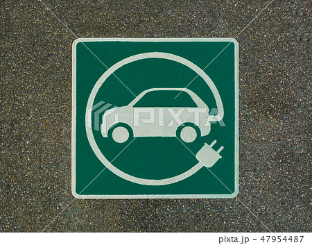 EV - electric vehicle charging station sign. 'E' sign on asphalt texture EV - electric vehicle charging station sign. 'E' sign on asphalt texture 47954487