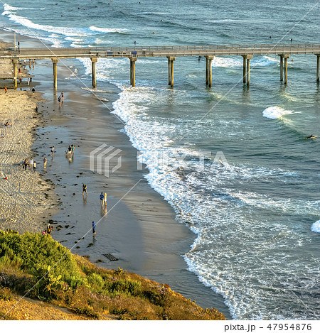 Scripps Pier and people at Pacific Ocean shoreline 47954876