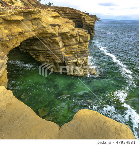Rugged cave and cliff bordering the Pacific Ocean Rugged cave and cliff bordering the Pacific Ocean 47954931