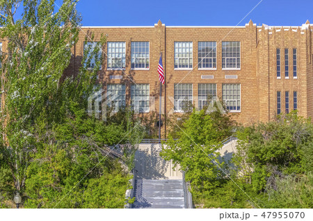 Public stairs with red building and flag 47955070