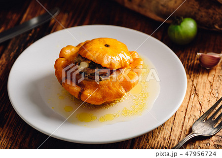 Stuffed pattypan squash on white plate Stuffed pattypan squash on white plate 47956724