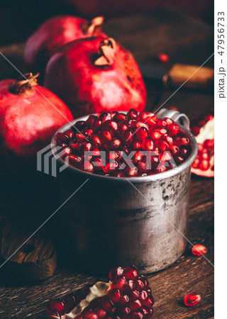 Metal mug full of the pomegranate seeds Metal mug full of the pomegranate seeds 47956733