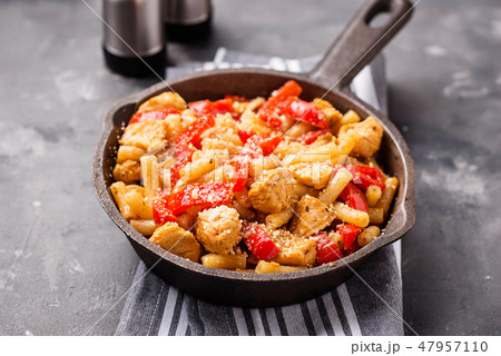 Pasta with chicken and pepper in tomato sauce 47957110