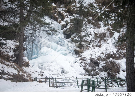 Frozen waterfall in the woods in the mountains. 47957320