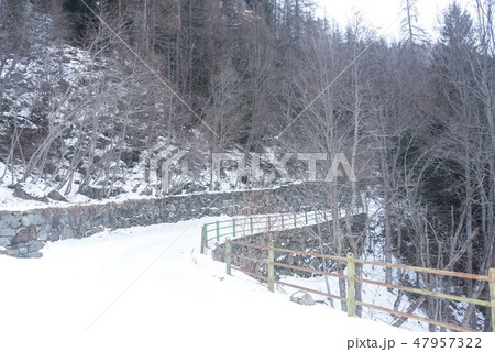 Mountain snowy road in the winter forest. 47957322