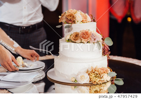Beautiful delicious white wedding cake. Wedding day Beautiful delicious white wedding cake. Wedding day 47957429