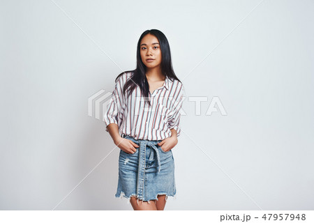 Pure beauty. Beautiful asian young woman in casual wear looking at camera and keeping hands in 47957948