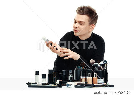 Professional makeup artist isolated on white 47958436