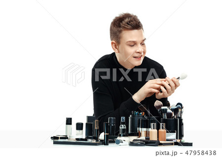 Professional makeup artist isolated on white Professional makeup artist isolated on white 47958438
