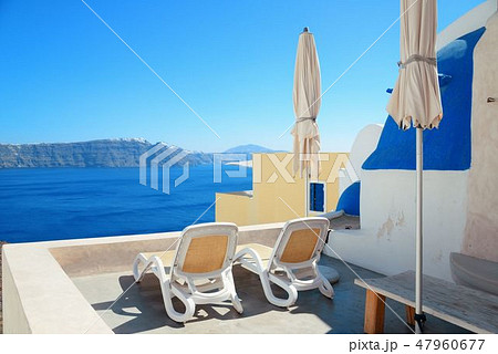 Santorini island leisure life with chair and umbrella Santorini island leisure life with chair and umbrella 47960677