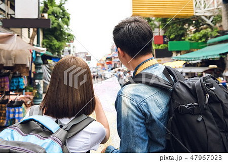 Tourist couple looking the on map while traveling Tourist couple looking the on map while traveling 47967023