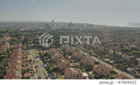 Aerial view of a residential area against air polluting plant Aerial view of a residential area against air polluting plant 47969422