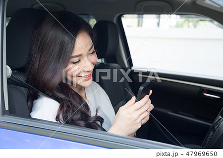 Young beautiful Asian woman smiling while Drive 47969650