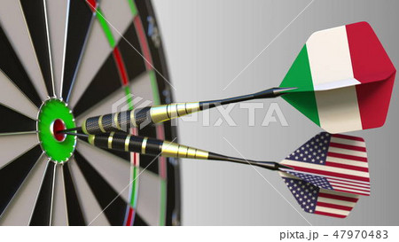 Flags of Italy and the USA on darts hitting bullseye of the target. International cooperation or 47970483