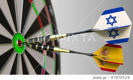 Flags of Israel and Spain on darts hitting bullseye of the target. International cooperation or 47970529