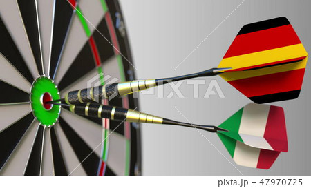 Flags of Germany and Italy on darts hitting bullseye of the target. International cooperation or 47970725