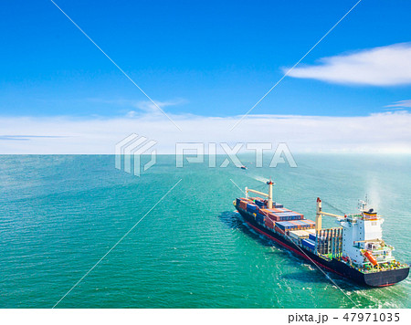 Aerial view of cargo ships that run in the middle Aerial view of cargo ships that run in the middle 47971035
