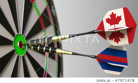 Flags of Canada and Russia on darts hitting bullseye of the target. International cooperation or Flags of Canada and Russia on darts hitting bullseye of the target. International cooperation or 47971478