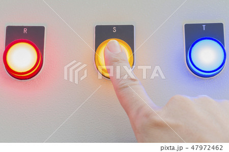 Forefinger touch on yellow stop button. 47972462