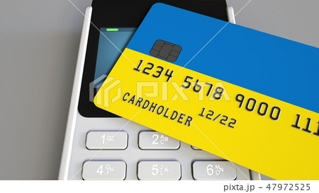 Payment terminal with credit card featuring flag of Ukraine. Ukrainian national banking system 47972525