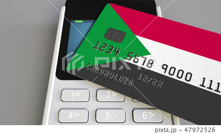 Payment terminal with credit card featuring flag of Sudan. Sudanese national banking system 47972526