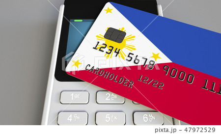 Payment terminal with credit card featuring flag of the Philippines. National banking system 47972529