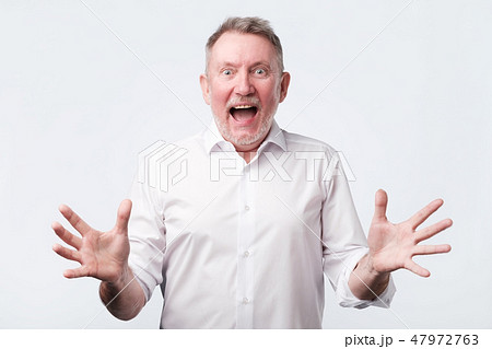 Happy senior man screams with happiness, celebrates his great triumph Happy senior man screams with happiness, celebrates his great triumph 47972763