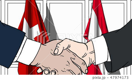 Businessmen or politicians shake hands against flags of Switzerland and Austria. Official meeting or 47974173