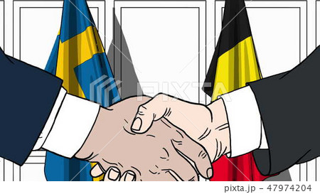 Businessmen or politicians shake hands against flags of Sweden and Belgium. Official meeting or 47974204