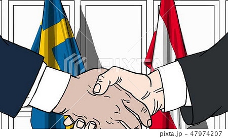 Businessmen or politicians shake hands against flags of Sweden and Austria. Official meeting or 47974207