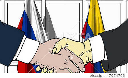 Businessmen or politicians shake hands against flags of Russia and Colombia. Official meeting or 47974706