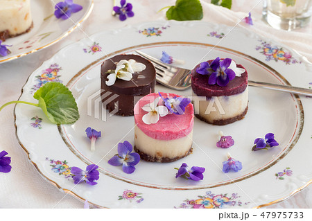 Raw vegan desserts with fresh violet flowers 47975733