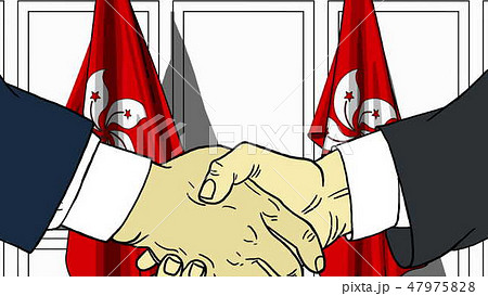 Businessmen or politicians shake hands against flags of Hong Kong. Official meeting or cooperation 47975828